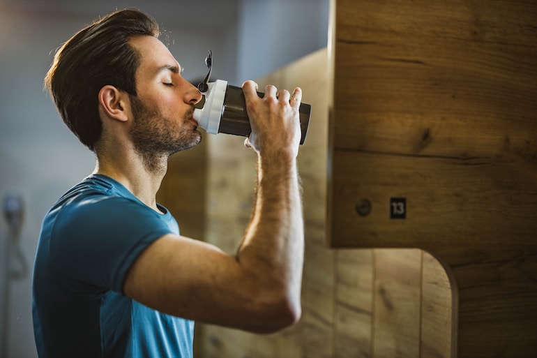 man drinking pre workout supplement